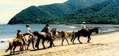Riding horses on the beaches of Manzanillo, Mexico