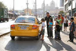 Taxi blocks traffic to pick up a fare